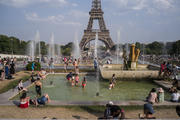 People enjoy the sun and the fountains of the Trocadero gardens in Paris, on Thursday July 25, 2019, when a new all-time high temperature of 42.6 degrees Celsius (108.7 F) hit the French capital. (AP Photo/Rafael Yaghobzadeh)