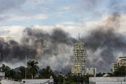 Clouds of smoke from burning cars mar the skyline of Culiacan, Mexico. The Mexican city lived under drug cartel terror for 12 hours as gang members forced the government to free a drug lord. (AP Photo/Hector Parra)