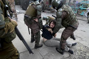 Police detain a demonstrator during an anti-government protest in Santiago, Tuesday, Nov. 5, 2019. Chileans have been taking to the streets and clashing with the police to demand better social services and an end to economic inequality, even as the government announced that weeks of demonstrations are hurting the country's economic growth. (AP Photo/Esteban Felix)