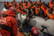 In this Sunday, Feb 18, 2018 file photo, refugees and migrants are rescued by aid workers of the Spanish NGO Proactiva Open Arms, after leaving Libya trying to reach European soil aboard an overcrowded rubber boat, 60 miles north of Al-Khums, Libya. (AP Photo/Olmo Calvo, file)