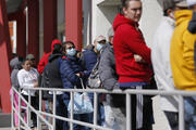 People wait in line for help with unemployment benefits at the One-Stop Career Center on March 17 in Las Vegas. (AP Photo/John Locher)