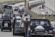 People transporting the remains of deceased loved ones wait in a slow moving line outside Jardines de la Esperanza Cemetery to hold burials in Guayaquil, Ecuador, on April 6, 2020. Guayaquil, a normally bustling city that has become a hot spot in Latin America as the coronavirus pandemic spreads, also has untold numbers dying of unrelated diseases that can't be treated because hospitals are overwhelmed. (AP Photo/Luis Perez)