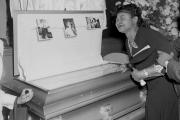 In this 1955 file photo, Mamie Bradley, mother of Emmett Till, pauses at her son's casket at a Chicago funeral home. 