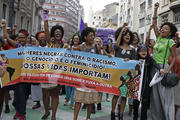 Activists march holding a banner that reads in Portuguese “Black women against racism, genocide and femicide. Our lives matter,” during a demonstration to mark International Women’s Day, in Sao Paulo, Brazil, on March 8, 2017. (AP Photo/Andre Penner)