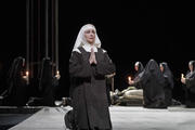 Nun kneeling on stage