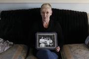 Helen McKendry holds a family photo with her mother, Jean McConville, at home in Killyleagh, Northern Ireland, in 2012 (AP Photo/Peter Morrison).