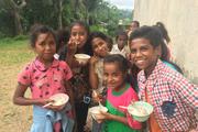 Feeding under nourished village children at Cocoa, East Timor.  Photo by Michael Sainsbury.