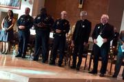 Dallas Auxiliary Bishop Gregory Kelly (left) and Bishop Edward J. Burns (right) meet with local law enforcment during a Dallas Area Interfaith meeting last November. Photo courtesy Dallas Area Interfaith