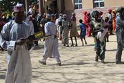 A security guard checks a handheld metal detector outside St. Hillary's Catholic Church in Maiduguri, Nigeria. Guards have intercepted suicide bombers attempting to enter the church compound. (Linus Unah)