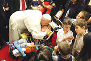 PAPAL BLESSING. Pope Francis kisses a child during a visit to the parish of Santa Maria dell’Orazione, on the outskirts of Rome, March 16.