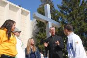 TRUE DIALOGUE. The Rev. Philip Lowe, chaplain of Neumann University in Aston, Pa., with students outside the campus chapel.