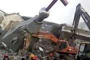 In this image taken from a video shot on Jan. 9, 2018, by China Aid and provided to the Associated Press, people in hard hats stand amid the remains of the Golden Lampstand Church in Linfen in northern China's Shanxi province. (China Aid via AP)