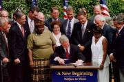 President Bill Clinton signing welfare reform legislation (Wikicommons).