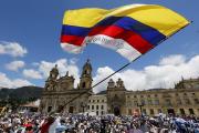 A man waves a national flag during the "March For Life" March 8, 2015 in Bogota, Colombia. The event supported peace negotiations between the government and the Revolutionary Armed Forces of Colombia (CNS photo/John Vizcaino, Reuters).