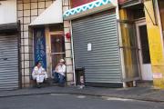 GOOD CONVERSATION. Two men take a smoke break in Old Chinatown in Manhattan.