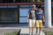 EMBRACING FAITH. Patrick Furlong, left, talks with LMU student Giovanni Falcon on an Ignacio Companions immersion trip in Santiago, Chile in 2014.