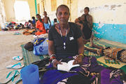 EXODUS. A woman fleeing an attack in South Sudan reads the Bible at a border gate in Joda, April 18, 2014. 