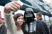 STAR WARS SELFIE. Ukrainian woman poses with a person dressed as Darth Vader.