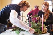 Denise Alexander and Madison Craig put the finishing touches on an Advent wreath at the Shrine of St. Anthony in Ellicott City, Md., Nov. 30. 