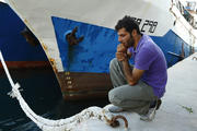 Syrian migrant attends commemorative service at harbor in Malta for immigrants who lost their lives at sea.