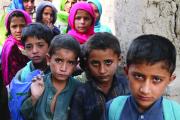 GETTING TO CLASS. Afghan children arrive at a school near a refugee camp near Kabul.