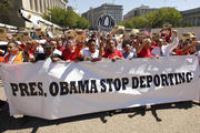 Protesters carry banner in front of White House during immigration march and rally