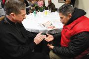 TURNING TOWARD MORNING. Archbishop Blase J. Cupich of Chicago blesses a rosary for Jaime Dones as he visited with patrons during a Thanksgiving dinner put on by Catholic Charities on Nov. 27, 2014. The dinner is held for the homeless and the hungry. 