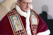 Pope Paul VI featured at his desk in the Vatican.