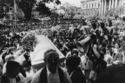 Thousands gather outside the Metropolitan Cathedral in San Salvador March 30, 1980, as the casket of slain Archbishop Oscar Romero is carried inside for a funeral Mass.