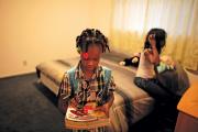 KEEPING UP? Jayla, left, prepares for her weekly Schools on Wheels tutoring session at a homeless shelter in Los Angeles, Calif.