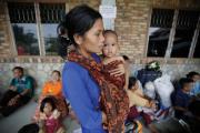 A Christian mother and child on Oct. 15 at a camp for displaced people at a Catholic school in Manduamas, Indonesia. More than 4,000 Aceh residents fled to North Sumatra following attacks by Islamic groups and the burning of two churches.