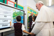 TASKMASTER. Pope Francis gets a lesson on the environment in East Harlem.