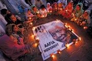 The world remembering Mandela: Children hold candles in a tribute to the former South African president in Karachi, Pakistan, on Dec. 6.