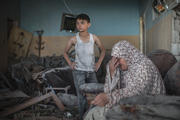 COLLATERAL DAMAGE. A Palestinian woman weeps on July 17 in what remains of her Gaza City home. the death toll in Gaza exceeded 510, mostly noncombatants, on July 21.