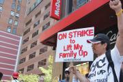 FAST FOOD, LOW WAGES. A worker joins a nation-wide campaign outside a Midtown Manhattan McDonald’s