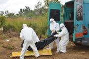 WORK OF MERCY. Health workers at a burial in northern Sierra Leone. 