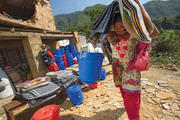 CONTAINING A CRISIS. Catholic Relief Services’ staff distribute shelter and hygiene kits in a village in Nepal’s Gorkha District.