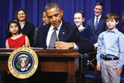 President Barack Obama signs executive orders on Jan. 16.