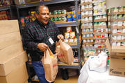 New Costumers: A volunteer prepares packages at a Catholic Charities food pantry in Chicago.