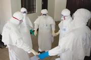 CIRCLE OF LIFE. Health workers at prayer as they start their shift in Monrovia, Liberia, in September.