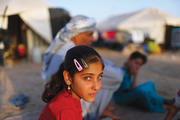 PERMANENT STATUS? An Iraqi child, who fled from ISIS militants in mosul, outside her tent at a camp in Erbil in September.