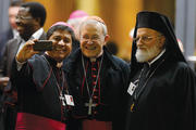 Selfie Reflection. An unidentified bishop with German Cardinal Walter Kasper and Melkite Catholic Patriarch Gregoire III Laham strike a pose after the synod’s final session on Oct. 24. 