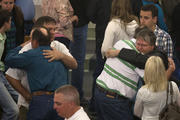 Residents embrace after service at Catholic church four days after deadly fertilizer plant explosion in Texas.