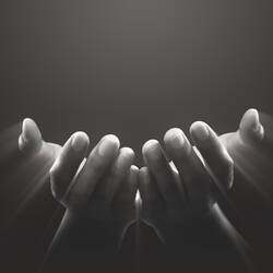 hands facing up with light reflecting