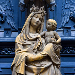statue of mary holding jesus, they are gold colored and slightly snowy