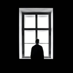 Man standing in front of the window