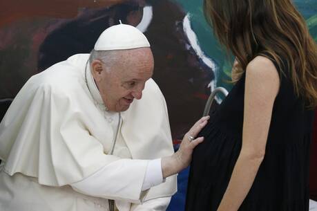 Pope Francis blesses a pregnant woman during a meeting of Scholas Occurentes in Rome May 19, 2022. (CNS photo/Paul Haring)