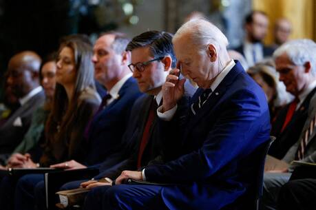 At center: Republican U.S. House Speaker Mike Johnson sits beside Democratic President Joe Biden during the annual National Prayer Breakfast at the U.S. Capitol in Washington on Feb. 1, 2024. (OSV News photo/Evelyn Hockstein, Reuters)