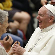 Pope Francis laughs as he greets a woman during an audience with people from Lyon, France, in Paul VI hall at the Vatican July 6. The audience was with 200 people living in difficult or precarious situations. (CNS photo/Paul Haring)