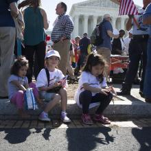 An immigration rally takes place April 18 outside the U.S. Supreme Court in Washington. The U.S. bishops' migration committee chair in a July 18 statement urged President Donald Trump to